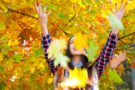 young girl with autumn leaves
