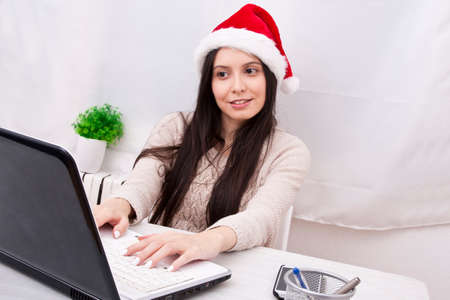 girl with christmas hat and computer