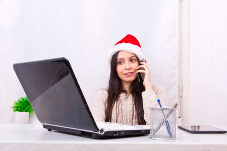 girl with computer and christmas hatの写真素材