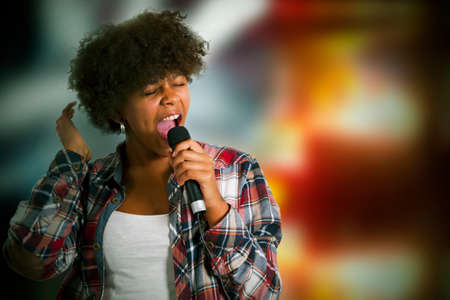 Girl singing with backlightsの写真素材