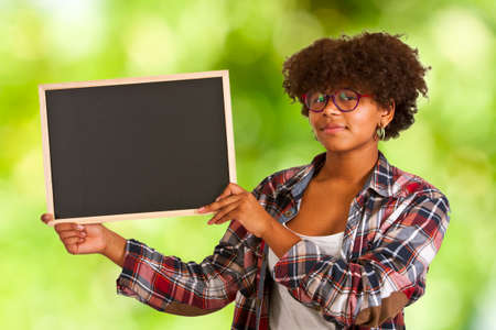 colored girl with blackboard on backgroundの写真素材