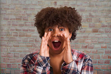 Latin American young woman screamingの写真素材