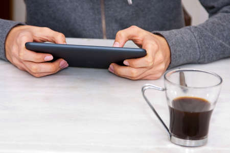 young teenage boy with the tablet in the foregroundの写真素材