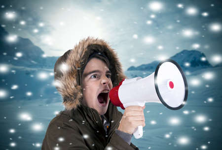child with megaphone on snowy landscapeの写真素材
