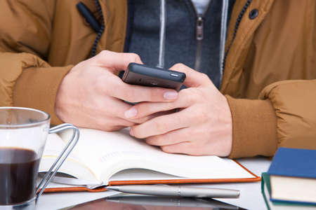 young boy with mobile phone in foreground