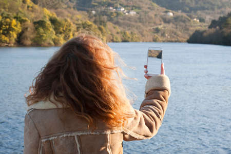 woman taking pictures with mobile phone