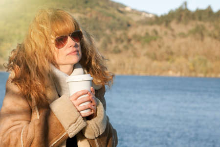 woman drinking coffee outdoors