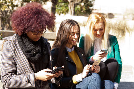 group of friends with mobile phoneの写真素材