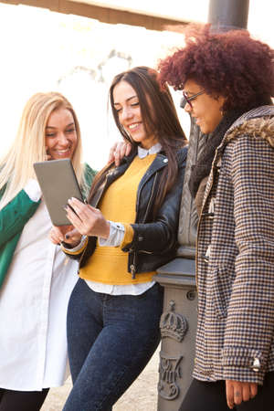 group of girls on the street with the tabletの写真素材