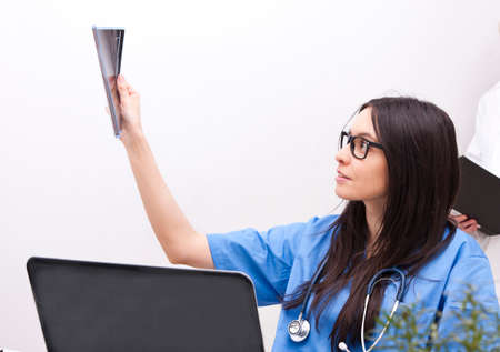 female doctor looking x-ray