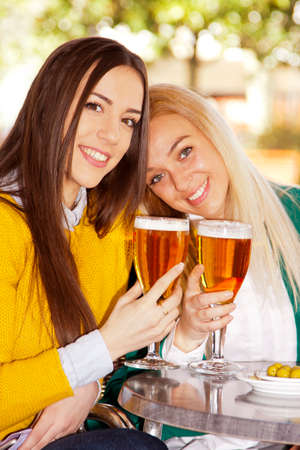 friends with beers on the terraceの写真素材