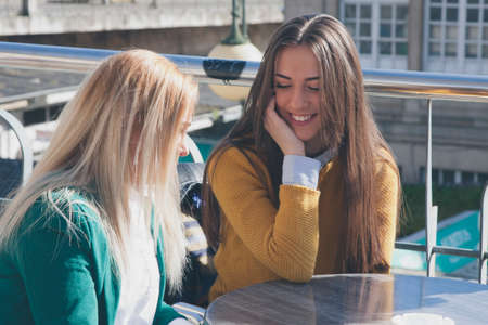 girls talking in the cafeteriaの写真素材