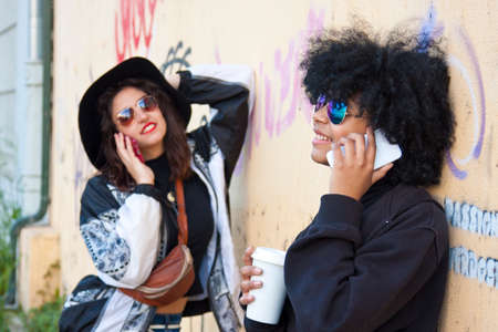 friends talking by mobile phoneの写真素材