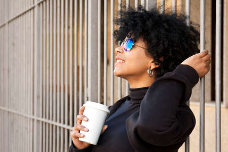 girl drinking coffee on the streetの写真素材