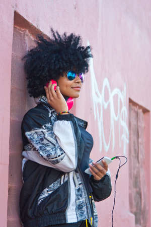 girl listening to music on the streetの写真素材