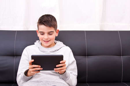 child with digital tablet at homeの写真素材