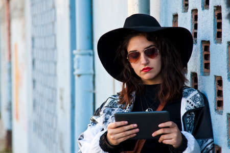 modern girl with the tablet on the streetの写真素材