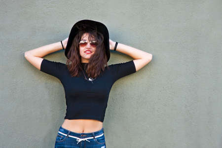 fashion girl with hat on the wallの写真素材