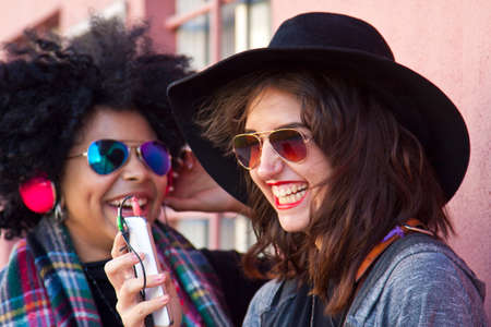 female friends listening to musicの写真素材