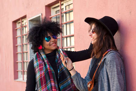 female friends listening to musicの写真素材