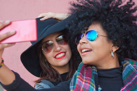 girls getting a selfie with mobileの写真素材