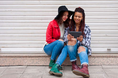 friends with the tablet on the street