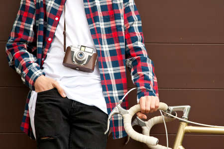 fashionable guy with the camera and bicycle