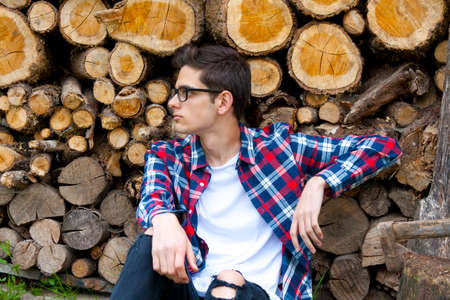 young guy with firewoodの写真素材