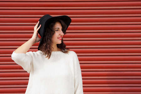hipster girl with hat in the streetの写真素材