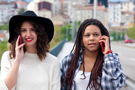 talking on the mobile phone on the streetの写真素材