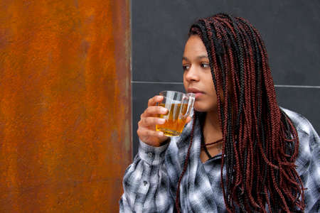 woman drinking coffee outdoorsの写真素材