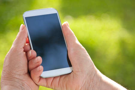 elderly hands with mobile phone