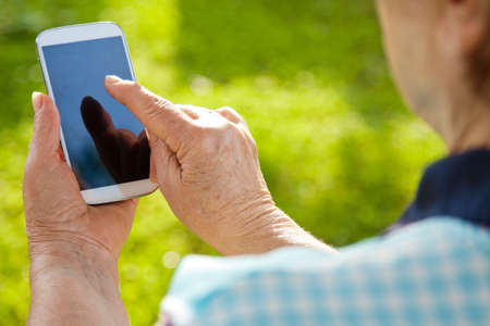 elderly hands with mobile phone