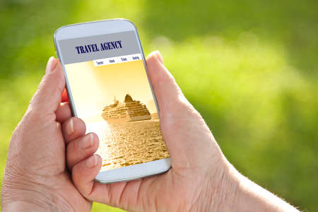 hands more buying travel onlineの写真素材