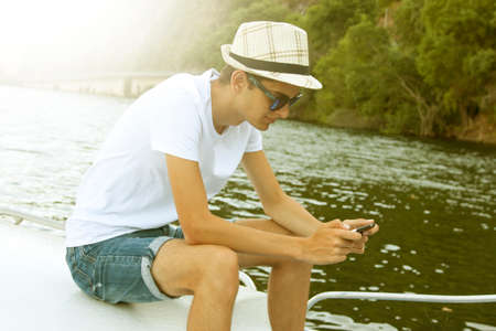 man on the yacht in summer at sunsetの写真素材