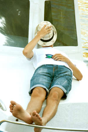 man holiday on the yacht lying at sunset in summer