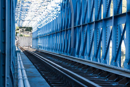 railway line passing through metallic blue tunnelの写真素材
