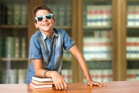 boy with books in the school libraryの写真素材