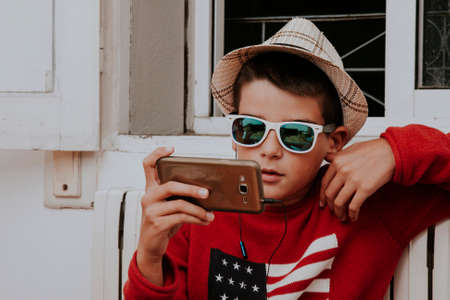 child with smartphone at homeの写真素材