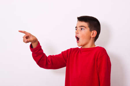 isolated child pointing surprised faceの写真素材