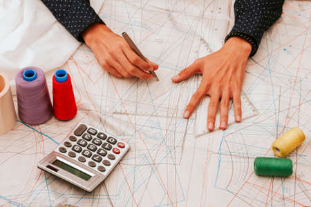 top view of the hands of the designer working at desk