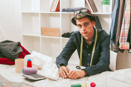 young man working in the fashion workshopの写真素材