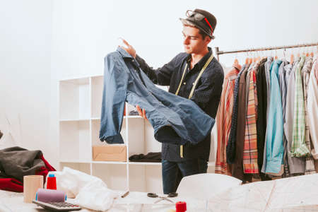 young man working in the fashion workshopの写真素材