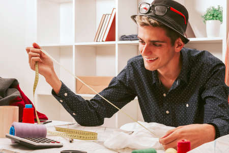 young man working in the fashion workshopの写真素材