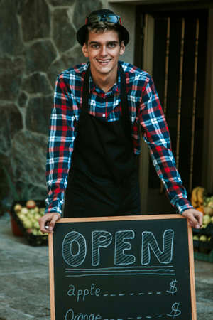 young man in his tent with blackboard advertising