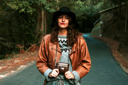 modern young woman with vintage camera photosの写真素材