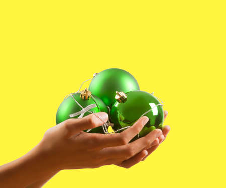 christmas ornaments and decorations on yellow backgroundの写真素材