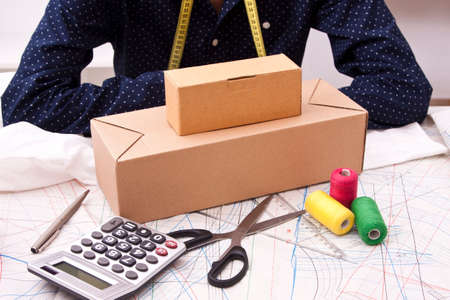 young man with cardboard boxes for shipping workshop