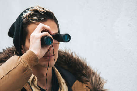 man with map and binoculars on white background outdoorsの写真素材