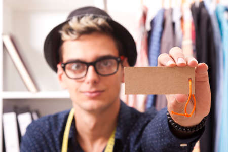 young man showing the label in the foregroundの写真素材